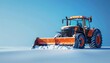 © Jakkapat - A powerful orange tractor clears the snow from a road. The snow is piled high on either side of the tractor. The tractor is leaving a clear path behind it.