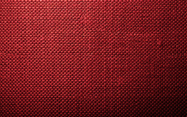 Close-up of textured red fabric, showcasing a detailed woven pattern for background or backdrop use in various design projects and visual content.