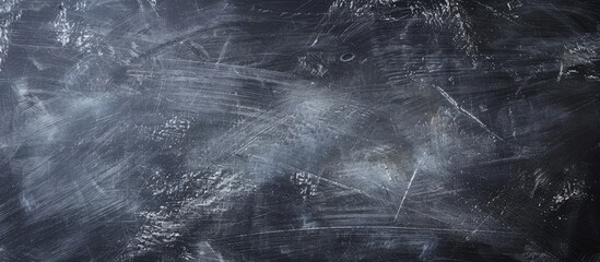 Poster - Blackboard surface with erased chalk creating an abstract background ideal as a blank canvas for images and text with copy space image