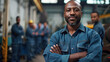 © Curva Design - happy black maintenance tech manager standing in front of a team of maintenance technicians with copy space for labor day background.