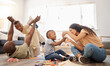 © peopleimages.com - Black family, toys and playing in home for fun, childcare and floor for games in living room. Parents, children and blocks for education in lounge, support and airplane flying or love for learning