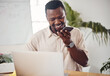 © peopleimages.com - Phone call, laptop and business man with mobile in office for conversation, advice or technical support. Talking, 404 error and black person for glitch, communication or help with internet connection
