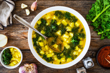 Canvas Print - Portuguese green soup - Caldo Verde.  Potato and kale soup served in white bowl on wooden table