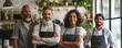 © Daniela - A group of four cheerful bakers, two men and two women, standing behind the counter in a modern café, showcasing a variety of baked goods and sweets on display