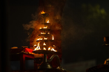 Wall Mural - 	
Ganga aarti, Fire flame at night with dark background during the ganga aarti rituals at river bank of Varanasi.	
