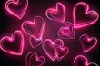 © sayan - Composition of pink neon hearts on a black background