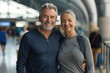© CogniLens - Portrait of a smiling couple in their 40s sporting a breathable mesh jersey while standing against bustling airport terminal background