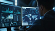 © VK Studio - An expert engrossed in studying vast amounts of data on multiple screens, illuminated only by the glow of the monitors in a dark room.