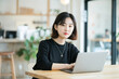 © Klay - young  korean  woman working on laptop in modern  comfy office setting