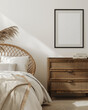 © Ignats - Bohemian-inspired bedroom with a rattan bed frame, soft bedding, and natural decor, featuring a blank framed mock-up poster on a white wall