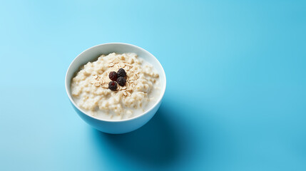 Wall Mural - Bol de porridge ou céréales avec du lait végétal. Fruits, fruits secs, myrtille. Bol sur un arrière-plan bleu clair. Nourriture, petit-déjeuner, manger. Pour conception et création graphique.