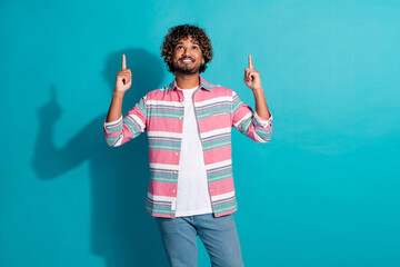 Sticker - Photo of young positive nice man wear trendy striped clothes introduce empty space isolated on cyan color background