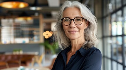 Canvas Print - A woman with glasses is smiling and posing for a picture