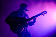 © Tony Baggett - Purple silhouette of a male guitarist musician playing an acoustic guitar in an abstract music theme setting performing at a concert hall for a poster or flyer, musical stock illustration image