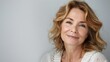 © Photolife   - portrait of a beautiful middle-aged Caucasian woman with well-skinned face looks at the camera, studio portrait, white background. copyspace