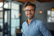 © FATNA - business man with shirt stands casually in modern glass office and smiles at camera - theme success, ERP, business or boss