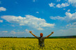© Yuriy Kulik - happy man stay among yellow rape field under blue cloudy sky