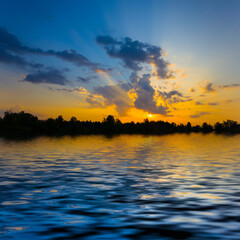 Wall Mural - dramatic sunset over a lake reflected in a water