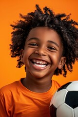 a young boy with curly hair holding a soccer ball