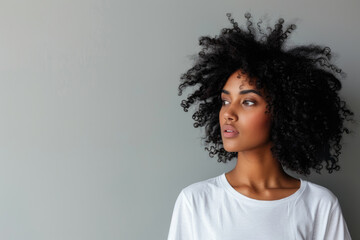 Wall Mural -  Beautiful black woman wearing bella canvas white t shirt and jeans, studio shot. Design t shirt template, print presentation mockup