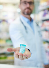 Wall Mural - Hand, pharmacist and bottle with pills for health, supplement or benefits for deal, service or wellness. Man, plastic container and drugs at pharmaceutical store with antibiotics, vitamin c or sale