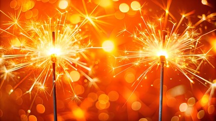 Wall Mural - Two burning sparklers with shiny lights at the edge of modern orange background, miracle candles party concept with copy space for happy new year, christmas and other holidays