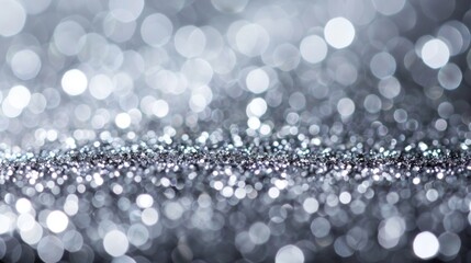abstract sparkling silver glitter bokeh background with bright and shimmering light effects