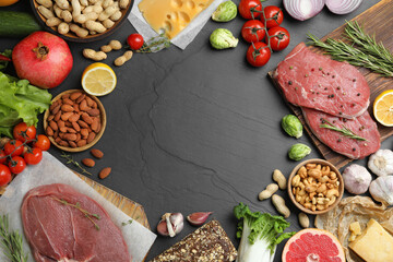 Wall Mural - Flat lay composition with fresh meat and other products on black table, space for text. Balanced diet