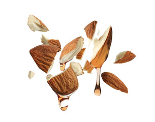 Wall Mural - Oil dripping from crushed almonds on white background