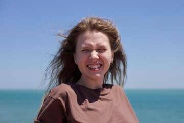 Wall Mural - portrait of a beautiful young woman at sea, relaxation concept, enjoying, freedom, closed eyes, smile