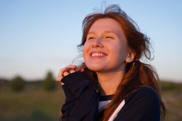 young woman or teenager portrait enjoying sunset and nature