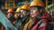 © Pixel - Group of Construction Workers Examining Blueprints at Job Site