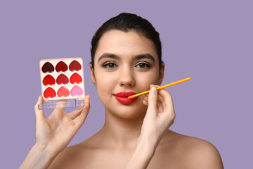 Poster - Female makeup artist working with young woman on lilac background