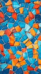 Wall Mural - A close-up shot of a mosaic wall made up of irregularly shaped tiles in shades of blue, orange, and red