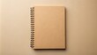 © Udomner - Spiral cardboard notebook made with recycled material, top view mockup on beige background, recycled, eco-friendly