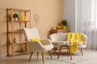 © Pixel-Shot - Interior of modern living room with white sofa, armchair, yellow plaid, coffee table and shelving unit