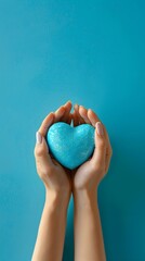 Young women hands holding blue heart on blue background, health care, donate and family insurance concept,world heart day, world health day, CSR responsibility, Mother's day