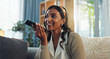 © WesSide/peopleimages.com - Woman, speaker and smartphone in home for discussion, smile and voice note in living room. Communication, social media and technology for announcement, mobile app and happy female person in lounge