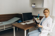 © Roman - Female doctors hand pointing at x-ray or MRI medical imaging with a head and neck condition. Spinal cord, blood vessels. Neuro medicine. Healthcare and medicine. Brain tissues.