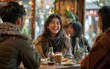 © imagineRbc - A group of people are sitting at a table in a restaurant, smiling and laughing. The woman in the center is wearing a scarf and she is enjoying her meal. The atmosphere is cheerful and friendly