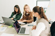 © Ilona - Three business women partners are working on a project in a bright office.