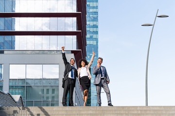 Wall Mural - Multiracial group of business people bonding outdoors - International business corporate team wearing elegant suit meeting in a business park