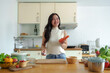 © crizzystudio - Exercise, diet, maintaining figure, fresh food that is important for losing weight and perfect health. Beautiful Asian woman peeling and chopping carrots to make a salad to eat at home.