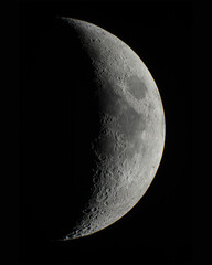Wall Mural - half moon with moon craters on a dark space background high definition