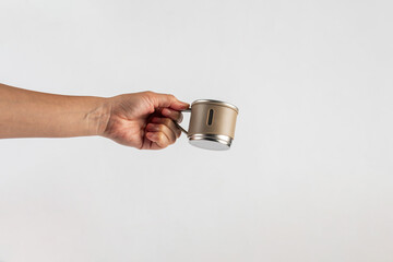 Stainless steel cup in hand isolated on white background