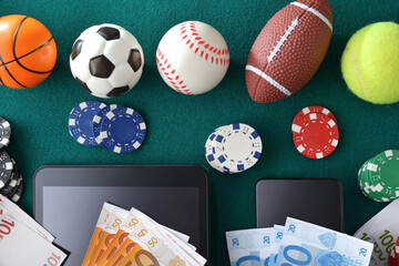 Online sports betting with devices on a green gaming mat