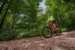© Sergey Novikov - Cyclist teen enjoying ride through a scenic, lush green forest