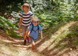 © Sergey Novikov - Three children hiking through forest, enjoy an outdoor adventure