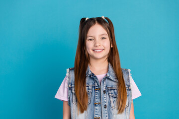 Poster - Photo portrait of cute little girl cheerful smile look camera dressed stylish denim clothes isolated on blue color background