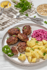 Wall Mural - frikadeller, danish meatballs on a plate, top view